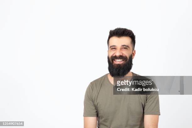 bearded young man looking at camera and smiling. - business man laughing stock pictures, royalty-free photos & images