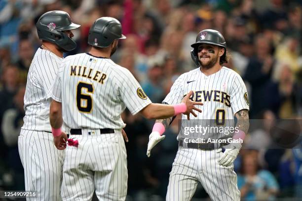 Brice Turang of the Milwaukee Brewers celebrates with teammates after hitting a home run during the third inning of the game between the Kansas City...