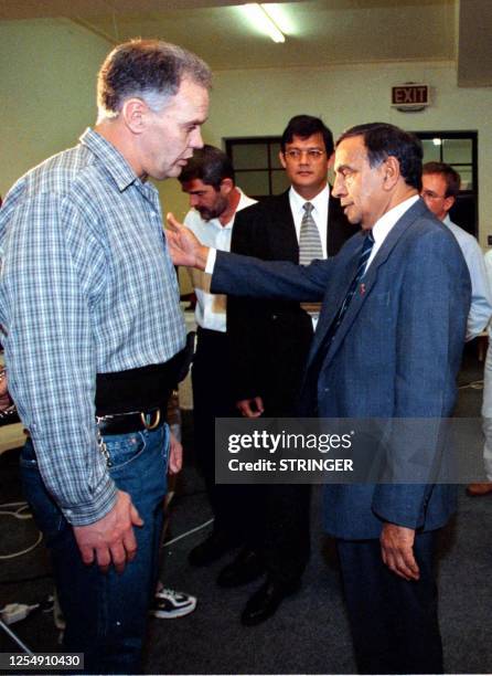 Transport minister Dullah Omar makes a concilliatory gesture to convicted killer and former apartheid assassin Ferdi Barnard during a break at a...