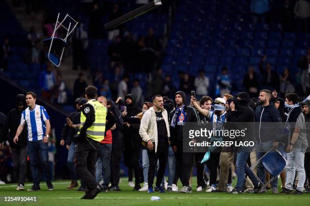 Espanyol fans react to Barcelona's victory invading the pitch after the Spanish league football match between RCD Espanyol and FC Barcelona at the...