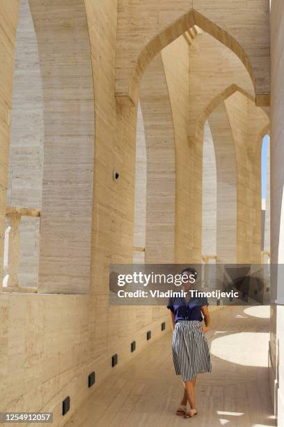 girl walking through arcades - doha people stock pictures, royalty-free photos & images