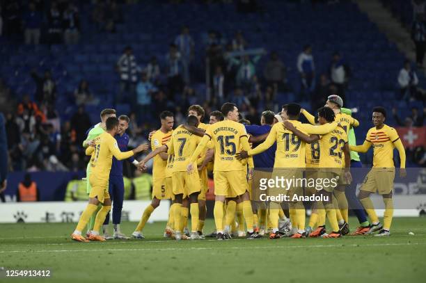 Players of FC Barcelona celebrate their victory at the end of the Spanish league football match between RCD Espanyol vs FC Barcelona at the...