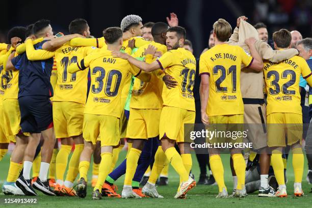 Barcelona's players celebrate winning their 27th Spanish league championship after the Spanish league football match between RCD Espanyol and FC...