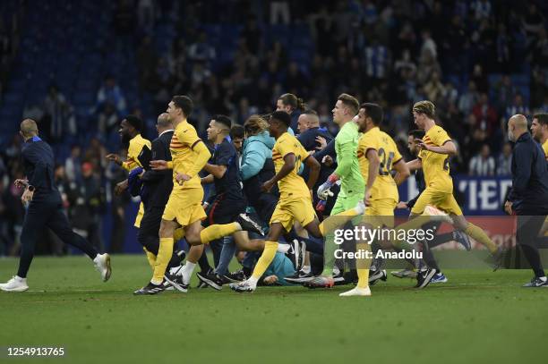 Players of FC Barcelona celebrate their victory at the end of the Spanish league football match between RCD Espanyol vs FC Barcelona at the...
