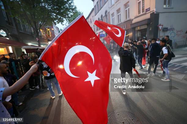 Turkish people gather with Turkish flags at Schaerbeek, in Brussels, Belgium after voting for Turkish presidential and parliamentary elections ended...