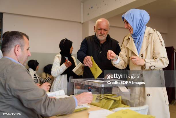 Man casts his vote in a ballot box at Saffet Çebi school polling station. 64 millions Turkish citizens are called to head to the polls today to vote...