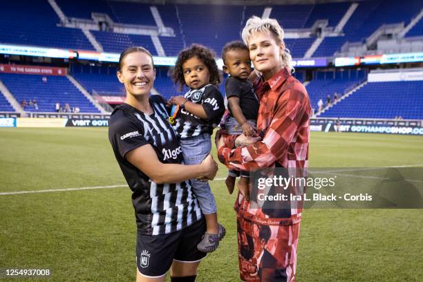 Ali Krieger of NJ/NY Gotham FC and Ashlyn Harris, former NJ/NY Gotham FC player hold their children after the Mothers Day National Women's Soccer...