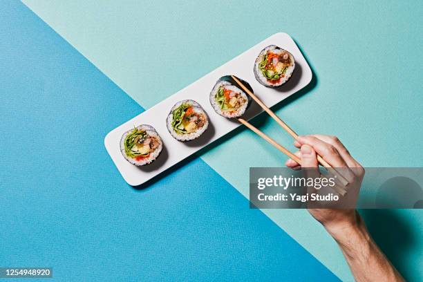 colorful color scheme background and korean gimbap - sushi chopsticks stock pictures, royalty-free photos & images