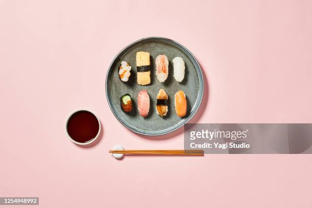 sushi with pink background - eetstokje stockfoto's en -beelden