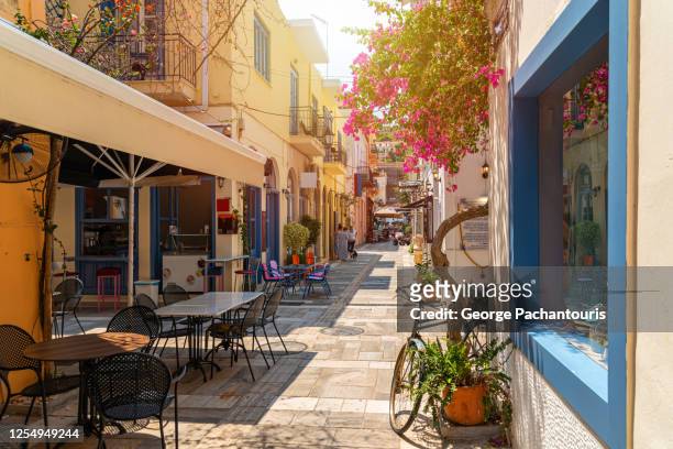 cafe in a beautiful alley in nafplio, greece - outside cafe stock pictures, royalty-free photos & images