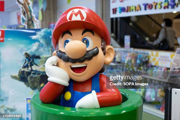 Nintendo's Super Mario figurine at a toy store entrance in Yokohama. A recently released animated film called The Super Marios Bros. Movie has...