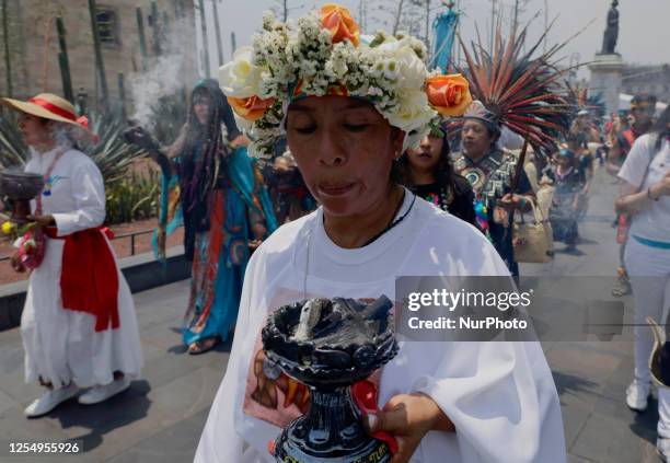 Woman holds an incense burner during a procession for the Toxcatl Ceremony in the Zocalo in Mexico City, which represents one of the most important...