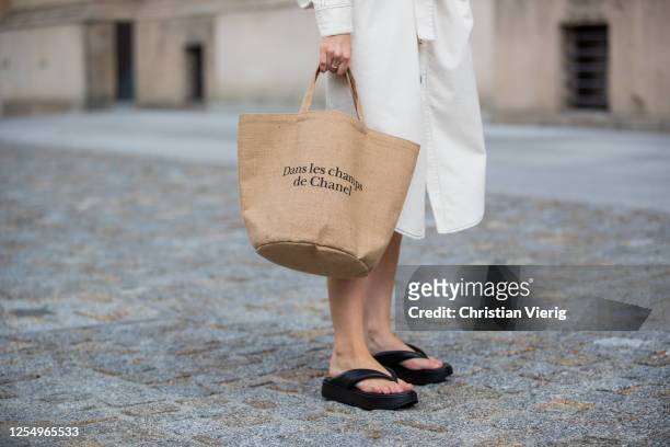 Swantje Soemmer is seen wearing white dress Blanche, Arket plateau flip flops, Chanel beach bag on July 07, 2020 in Berlin, Germany.