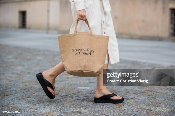 Swantje Soemmer is seen wearing white dress Blanche, Arket plateau flip flops, Chanel beach bag on July 07, 2020 in Berlin, Germany.