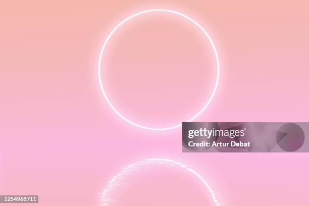 perfect neon ring glowing at sunrise sky levitating over the sea in surreal landscape. - zen like abstract stock pictures, royalty-free photos & images