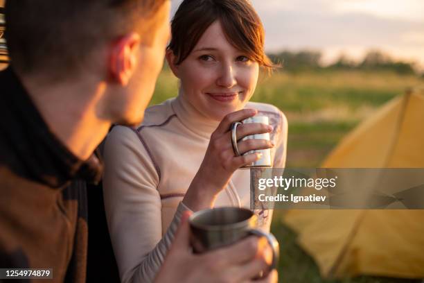 a couple of young man and woman with mugs - tea outdoor stock pictures, royalty-free photos & images