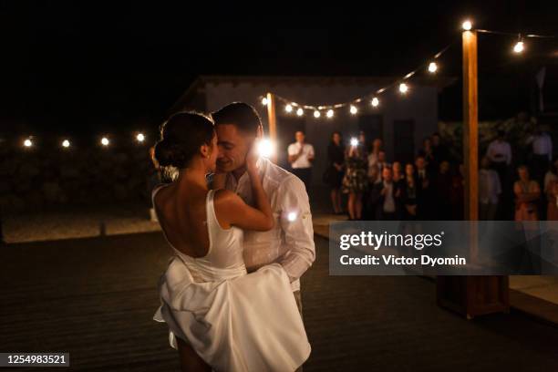 newlyweds are kissing at the dancing stage - wedding elegant ストックフォトと画像