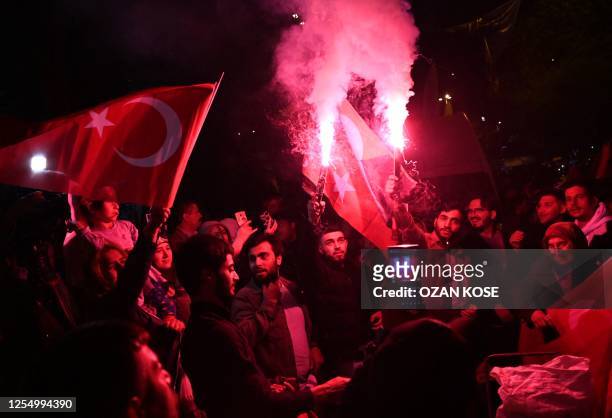 Supporters of Turkish President celebrate in front of the Justice and development Party headquarters after polls closed in Turkey's presidental and...