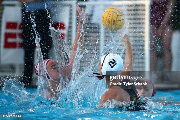 Jenna Flynn of the Stanford Cardinal blocks a shot on goal by Honnie Vandeweghe-O'Shea of USC Trojans during the Division I Women's Water Polo...