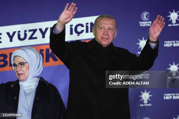 Turkish President Tayyip Erdogan , accompanied by his wife Ermine Erdogan , waves to supporters at the AK Party headquarters in Ankara, Turkey May...