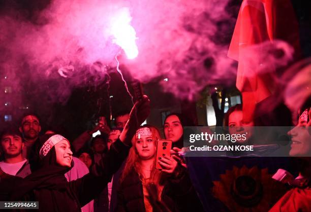 Supporters of Turkish President celebrate in front of the Justice and development Party headquarters after polls closed in Turkey's presidental and...