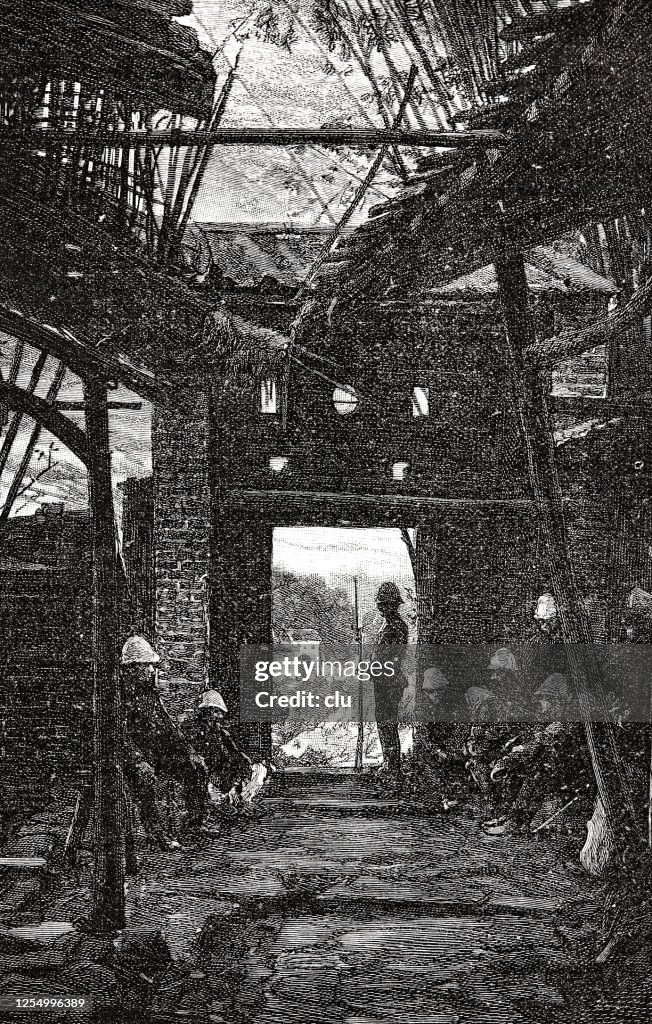 Persons sitting in a destroyed house