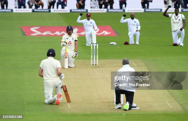 Rory Burns and Dom Sibley of England take a knee alongside Shane Dowrich, Jermaine Blackwood and Jason Holder of the West Indies during day one of...