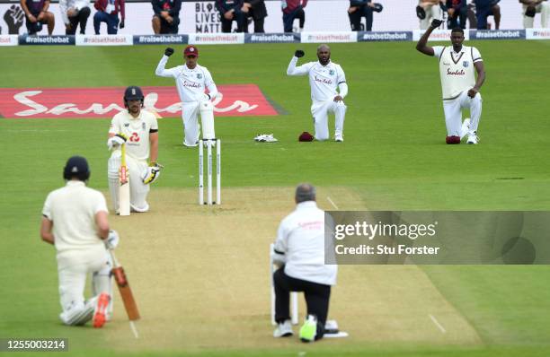 Rory Burns and Dom Sibley of England take a knee alongside Shane Dowrich, Jermaine Blackwood and Jason Holder of the West Indies during day one of...