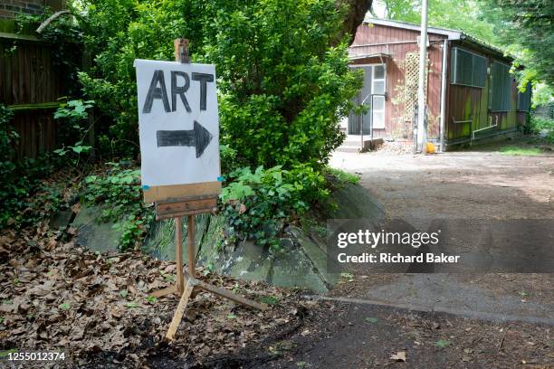 An arrow points to a nearby hut which is hosting the artworks of local painters, as part of the annual Dulwich Artists' Open House festival that...