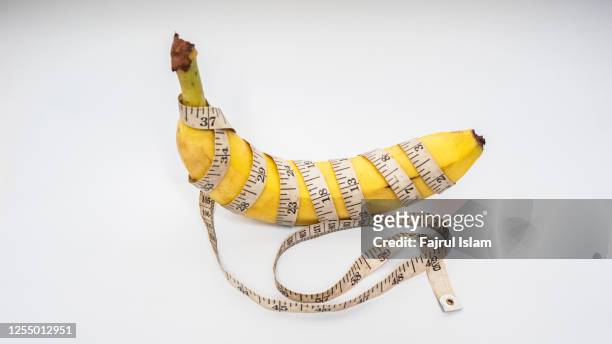 measure tape and banana size matters - penis humour stock pictures, royalty-free photos & images