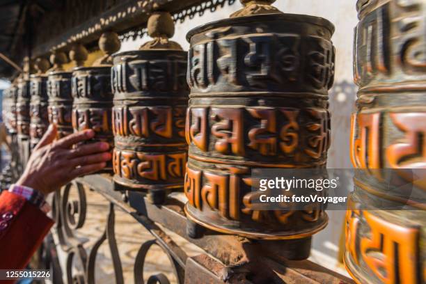 kathmandu buddhist prayer wheels spinning at swayambhunath monkey temple nepal - tibetan buddhism stock pictures, royalty-free photos & images