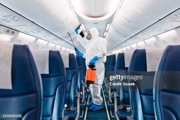 airplane disinfection due to covid-19 - covid-19 air travel stock pictures, royalty-free photos & images