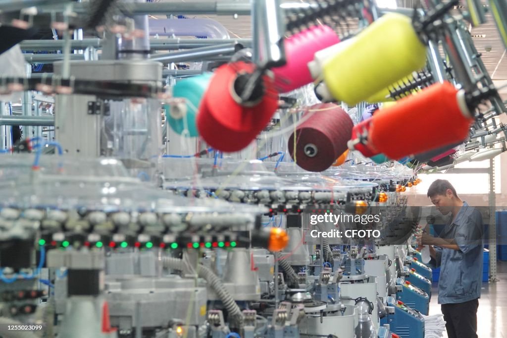 QINGDAO CHINA MAY 15 2023 A Worker Makes Clothing Products For qingdao-china-may-15-2023-a-worker-makes-clothing-products-for