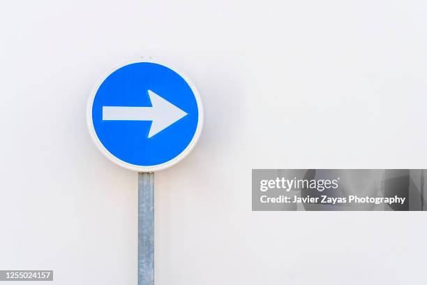 road sign against white wall - pfeil freisteller stock-fotos und bilder