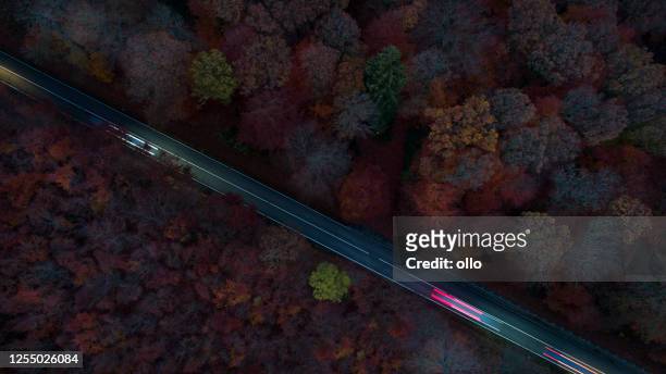 traffic on country road - long exposure, aerial view - dark country road stock pictures, royalty-free photos & images