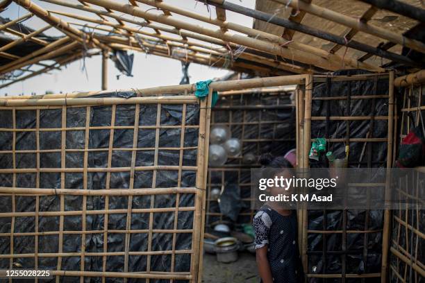 Girl inside a partially destroyed house after Cyclone Mocha'a landfall at Shah Porir dwip in Teknaf.