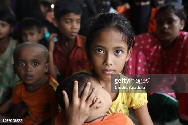 Rohingya children take shelter at a safer place due to Cyclone Mocha hitting in Bangladesh on May 14, 2023 in Teknaf, Bangladesh. According to...