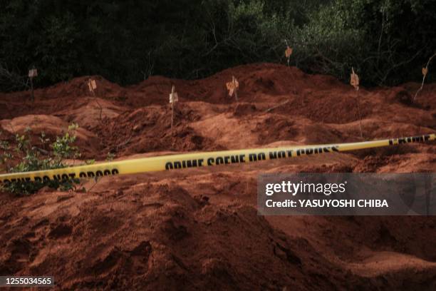 Digged holes are seen after exhuming bodies at the mass-grave site in Shakahola, outside the coastal town of Malindi, on April 25, 2023. The death...