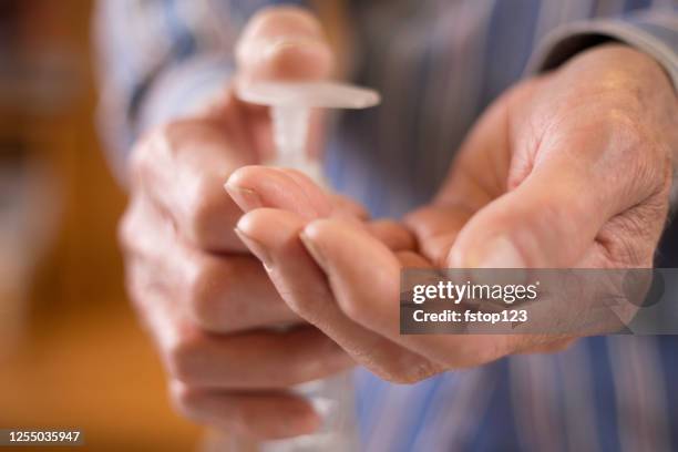 senior man using hand sanitizer - crack epidemic stock pictures, royalty-free photos & images