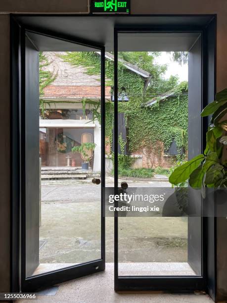 two open glass doors - sliding door stock pictures, royalty-free photos & images