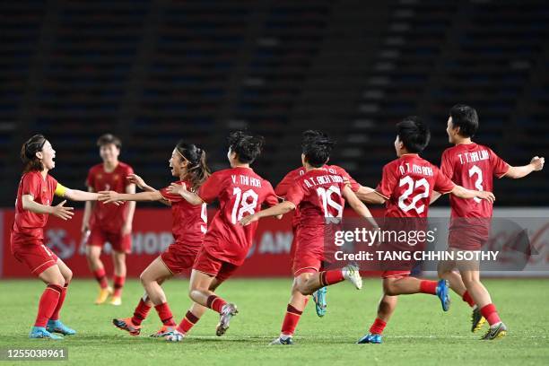 Vietnam's Hai Yen Pham celebrates with teammates after defeating Myanmar in the women's football final match during the 32nd Southeast Asian Games at...