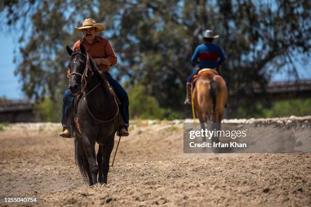 Riders on San Gabriel River eastern banks near Pellissier Village near Whittier.