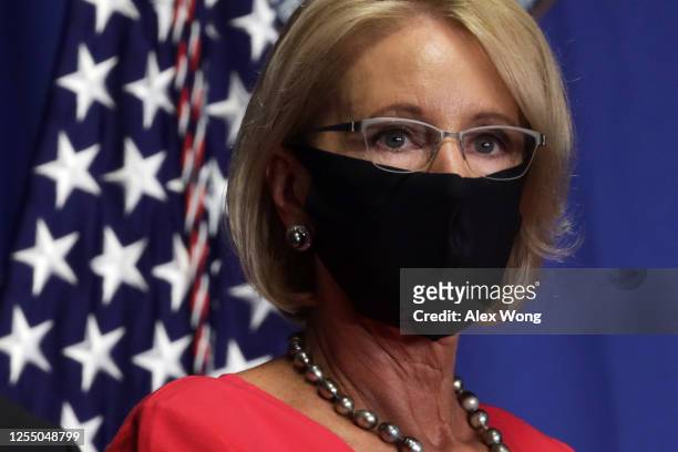 Secretary of Education Betsy DeVos listens during a White House Coronavirus Task Force press briefing at the U.S. Department of Education July 8,...