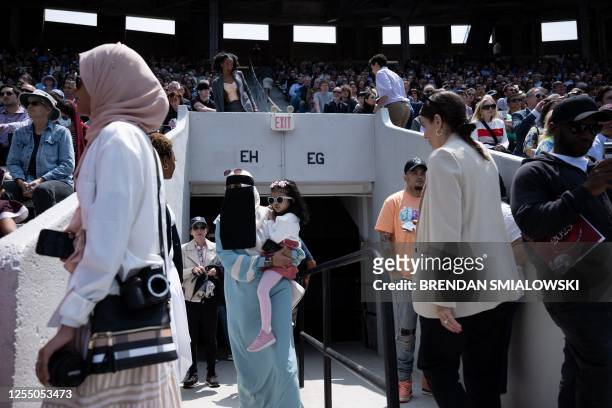 People listen as US President Joe Biden and others attend the University of Pennsylvania commencement ceremony at Franklin Field on May 15, 2023 in...