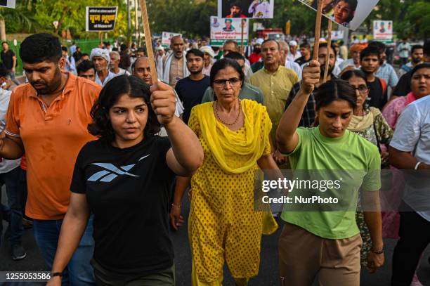 Indian Wrestlers Sakshi Malik and Vinesh Phogat walk during a march against the allegations of sexual harassment to athletes by the Wrestling...