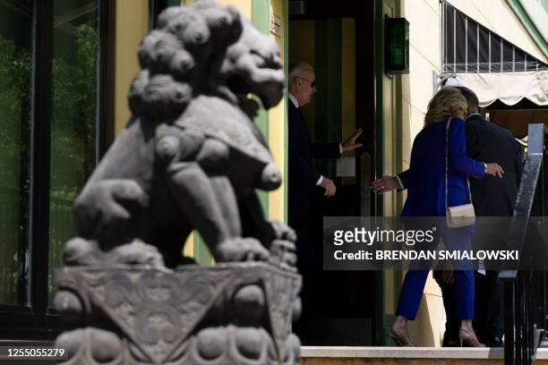 President Joe Biden and US First Lady Jill Biden leave following a lunch with friends and family at the Vietnam Cafe, after attending the University...