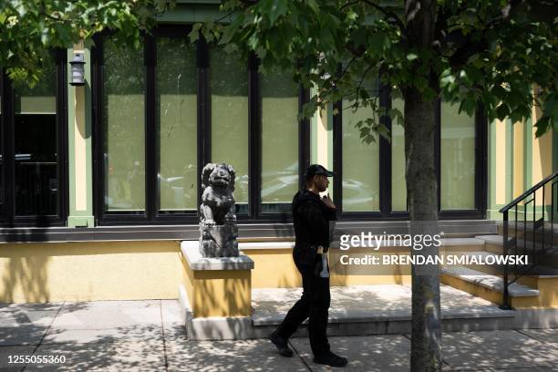 Member of the Secret Service stands guard while US President Joe Biden attends a lunch at the Vietnam Cafe with friends and family after attending...