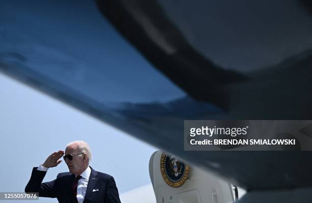 President Joe Biden salutes while boarding Air Force One at Philadelphia International Airport in Philadelphia, Pennsylvania, on May 15 as they...