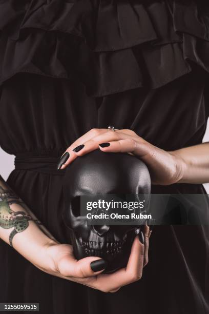 girl in black clothes holding black skull - dead women stock pictures, royalty-free photos & images