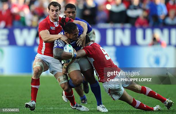 Samoa's left wing Alesana Tuilagi is tackled by Wales' flanker Sam Warburton during the 2011 Rugby World Cup pool D match Wales vs Samoa at Waikato...